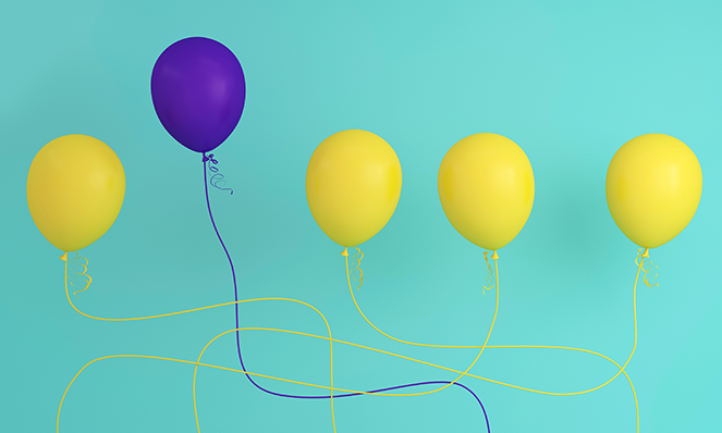 Purple balloon standing out against yellow balloons (branding metaphor)